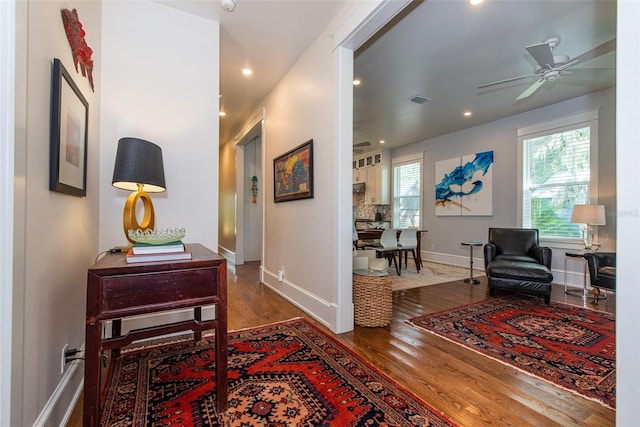 corridor with dark hardwood / wood-style flooring