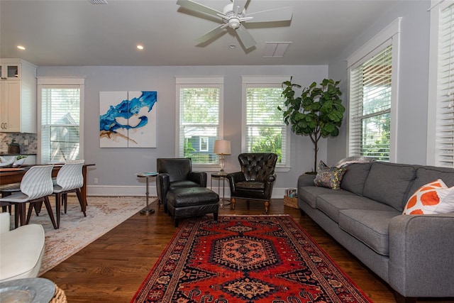 living room featuring ceiling fan and dark wood-type flooring