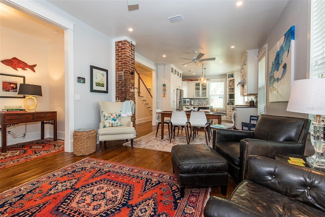 living room with ceiling fan and dark wood-type flooring