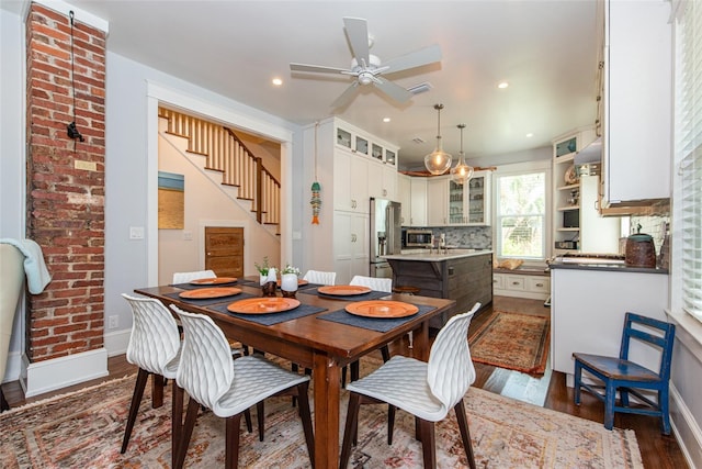 dining space with dark hardwood / wood-style floors, ceiling fan, and sink