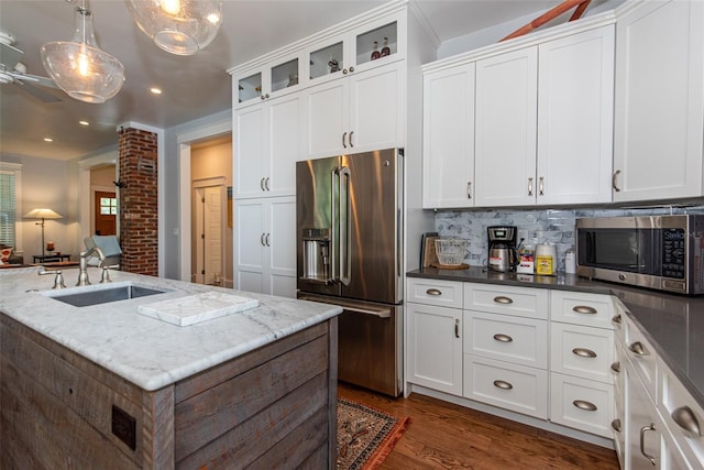 kitchen with white cabinetry, sink, decorative light fixtures, decorative backsplash, and appliances with stainless steel finishes