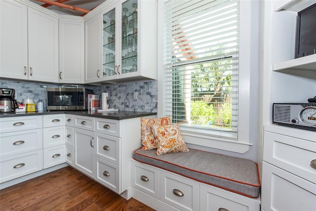 kitchen with white cabinets, decorative backsplash, and dark hardwood / wood-style floors