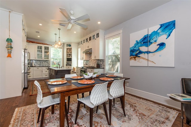 dining room featuring dark hardwood / wood-style floors, ceiling fan, and sink