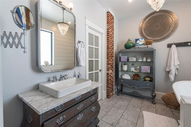 bathroom with a notable chandelier and vanity