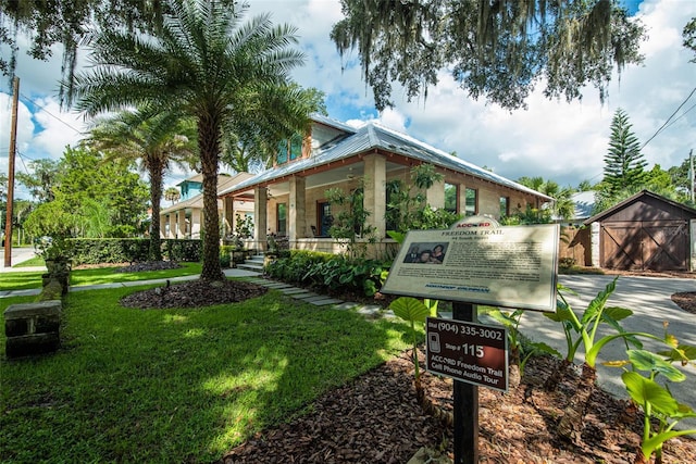 exterior space with a storage unit and a front yard