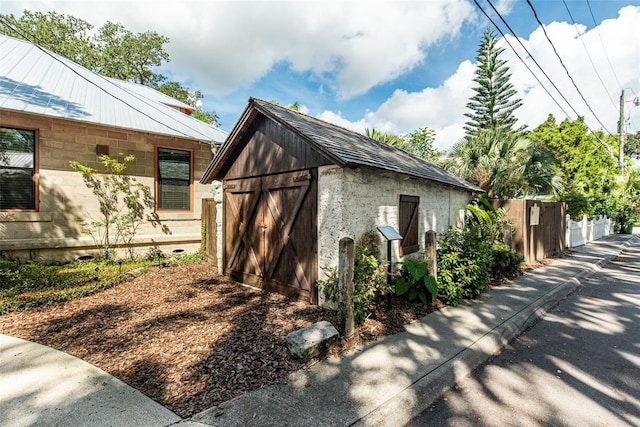 view of property exterior with a storage shed