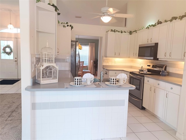 kitchen with ceiling fan, white cabinetry, pendant lighting, light tile patterned flooring, and appliances with stainless steel finishes