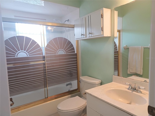 full bathroom with vanity, enclosed tub / shower combo, and toilet