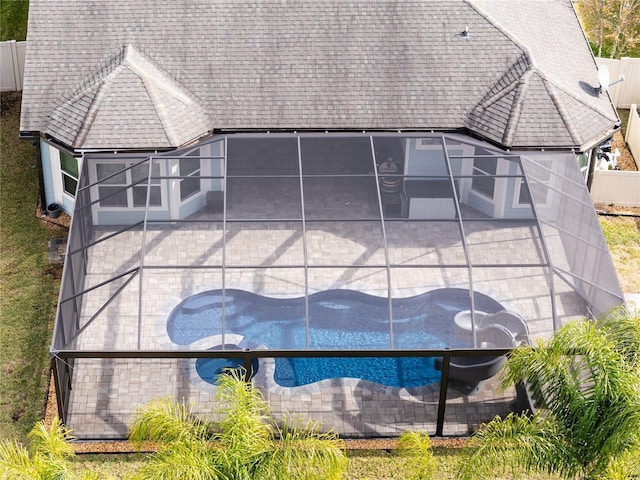 rear view of property featuring a lanai and a patio