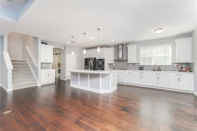 kitchen featuring black appliances, wall chimney range hood, washer / clothes dryer, and dark wood-style flooring