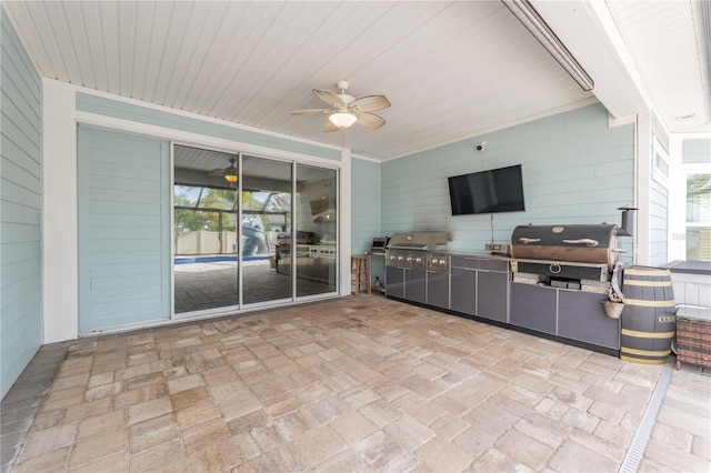 view of patio / terrace featuring ceiling fan, an outdoor kitchen, and area for grilling