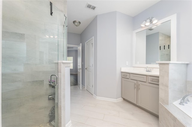 full bath with a stall shower, visible vents, baseboards, a garden tub, and vanity