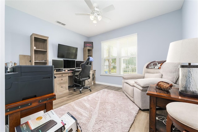 home office with baseboards, wood finished floors, visible vents, and a ceiling fan