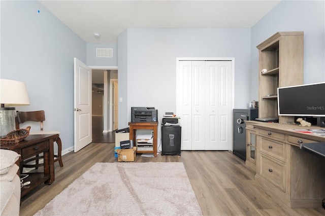 home office featuring visible vents and light wood-style flooring