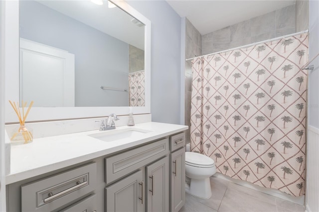 bathroom with a shower with shower curtain, vanity, toilet, and tile patterned floors