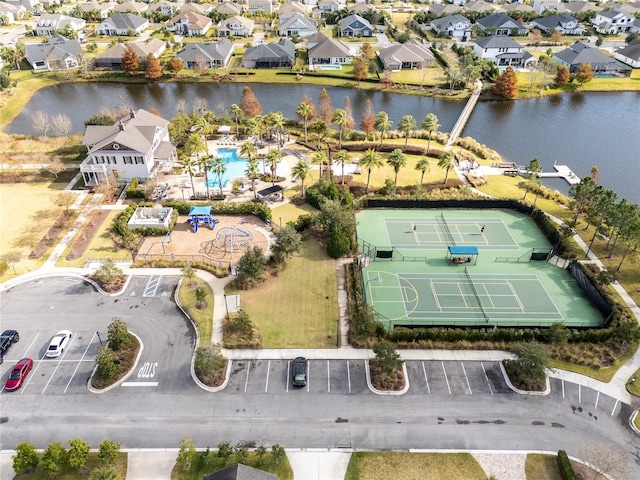 drone / aerial view with a water view and a residential view