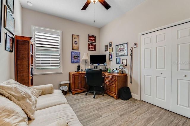 home office featuring light hardwood / wood-style floors and ceiling fan