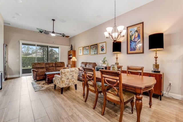 dining room with ceiling fan with notable chandelier