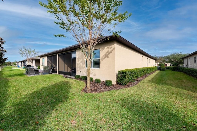 view of property exterior featuring a lawn and a sunroom