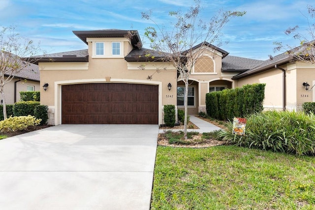 view of front facade with a front yard and a garage