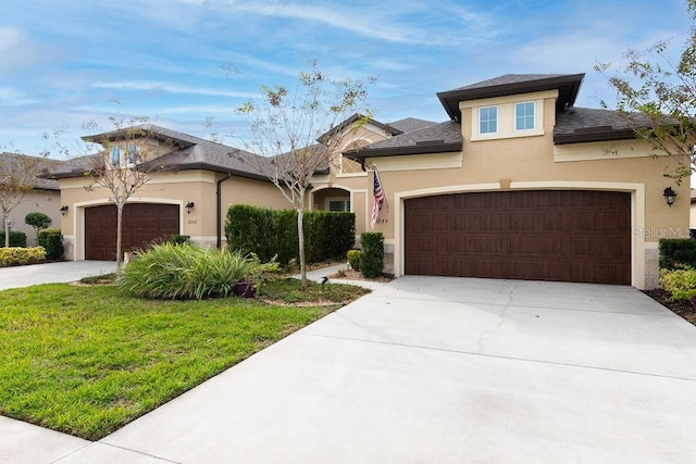 view of front facade with a front yard and a garage