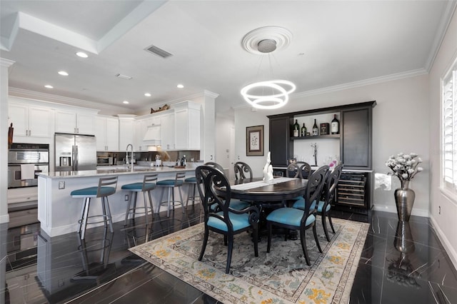 dining room with plenty of natural light, sink, and crown molding