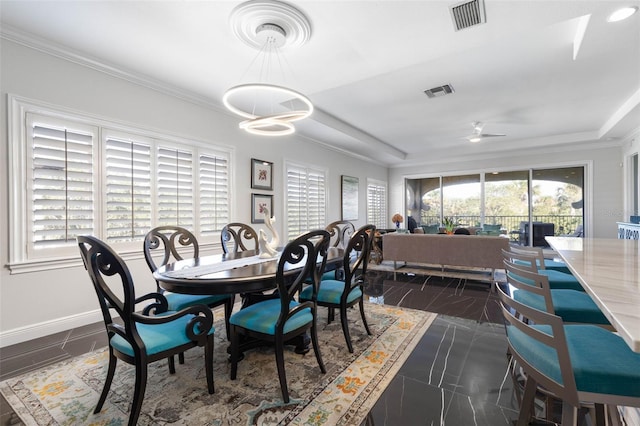 dining space with ceiling fan and crown molding