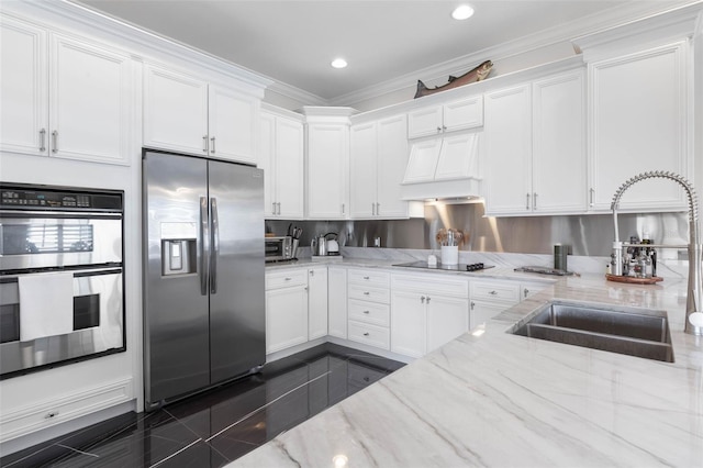 kitchen with light stone counters, stainless steel appliances, crown molding, sink, and white cabinetry