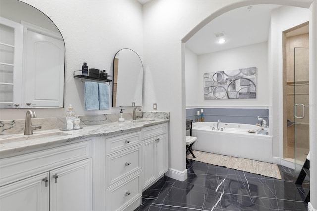 bathroom featuring tile patterned floors, vanity, and shower with separate bathtub