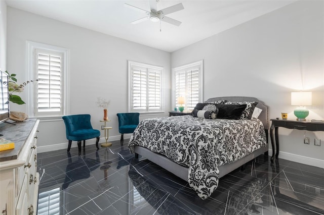 bedroom with ceiling fan and multiple windows