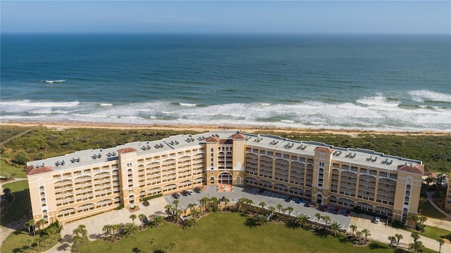 drone / aerial view featuring a water view and a beach view