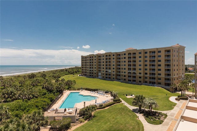 view of pool featuring a water view and a beach view