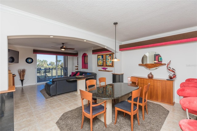 dining area with ceiling fan, crown molding, light tile patterned floors, and a textured ceiling