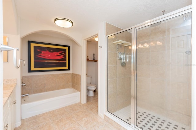 full bathroom featuring tile patterned flooring, vanity, shower with separate bathtub, and toilet