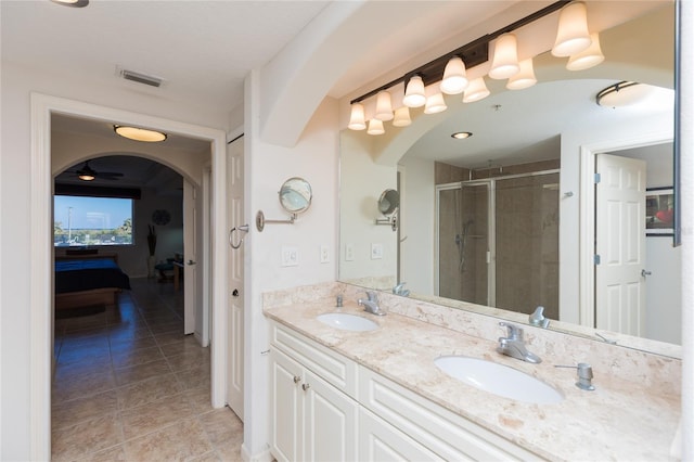 bathroom featuring ceiling fan, tile patterned flooring, vanity, and walk in shower