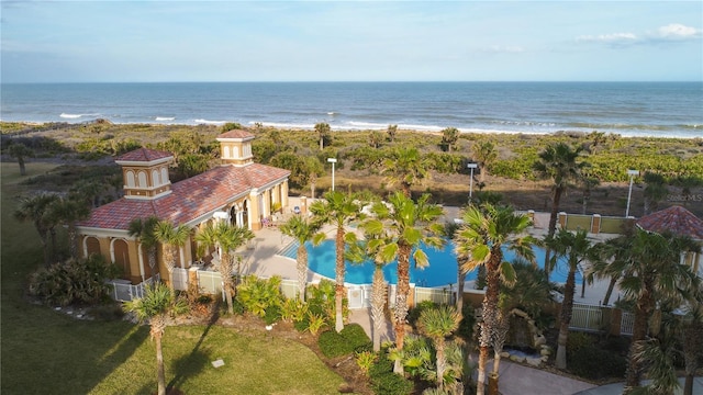 birds eye view of property featuring a water view and a beach view