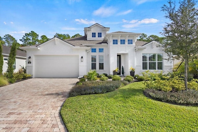 view of front facade with a front yard and a garage