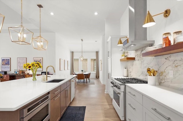 kitchen featuring tasteful backsplash, island range hood, high end white range oven, sink, and white cabinetry