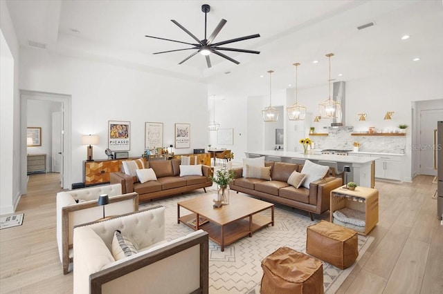 living room featuring light wood-type flooring and ceiling fan