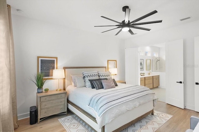 bedroom featuring ceiling fan, light wood-type flooring, and connected bathroom