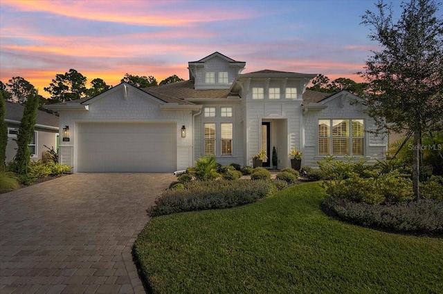 view of front of home featuring a yard and a garage