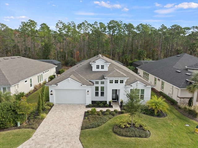 view of front of house with a garage and a front lawn