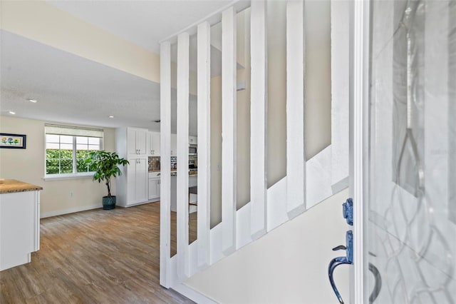 stairway featuring hardwood / wood-style flooring