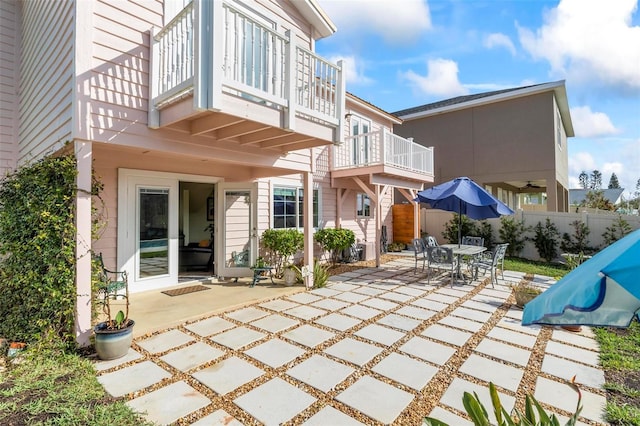 rear view of house featuring a patio area and a balcony