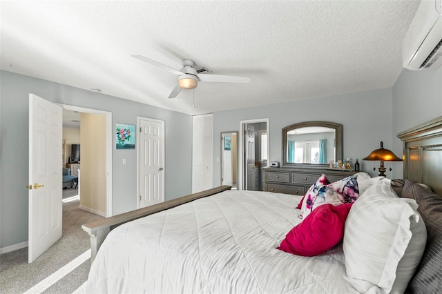 bedroom featuring carpet, ceiling fan, an AC wall unit, and a textured ceiling