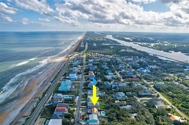 drone / aerial view with a beach view and a water view