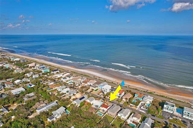 drone / aerial view featuring a water view and a view of the beach