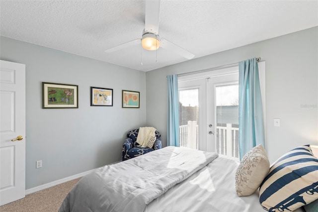 carpeted bedroom with baseboards, a textured ceiling, access to exterior, and a ceiling fan