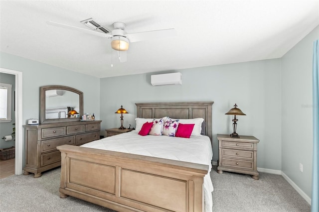bedroom featuring visible vents, baseboards, light colored carpet, a wall mounted air conditioner, and a ceiling fan