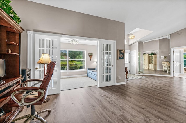 unfurnished office featuring french doors, wood-type flooring, and ceiling fan